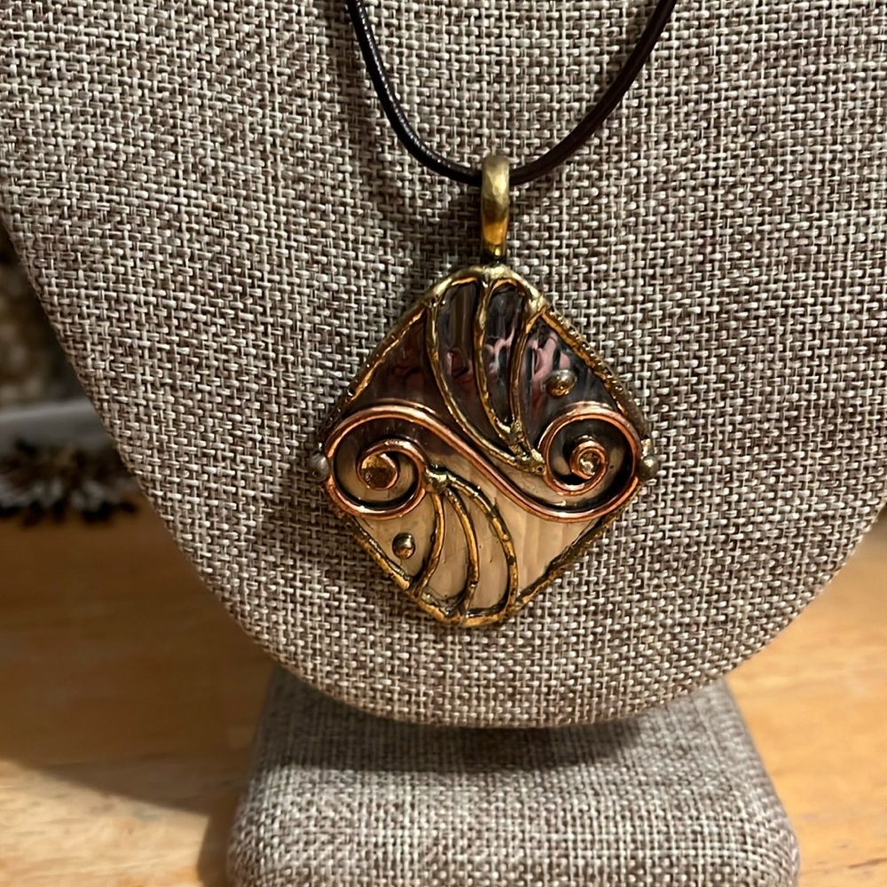 Artisan design necklace in silver, gold and copper tone metal